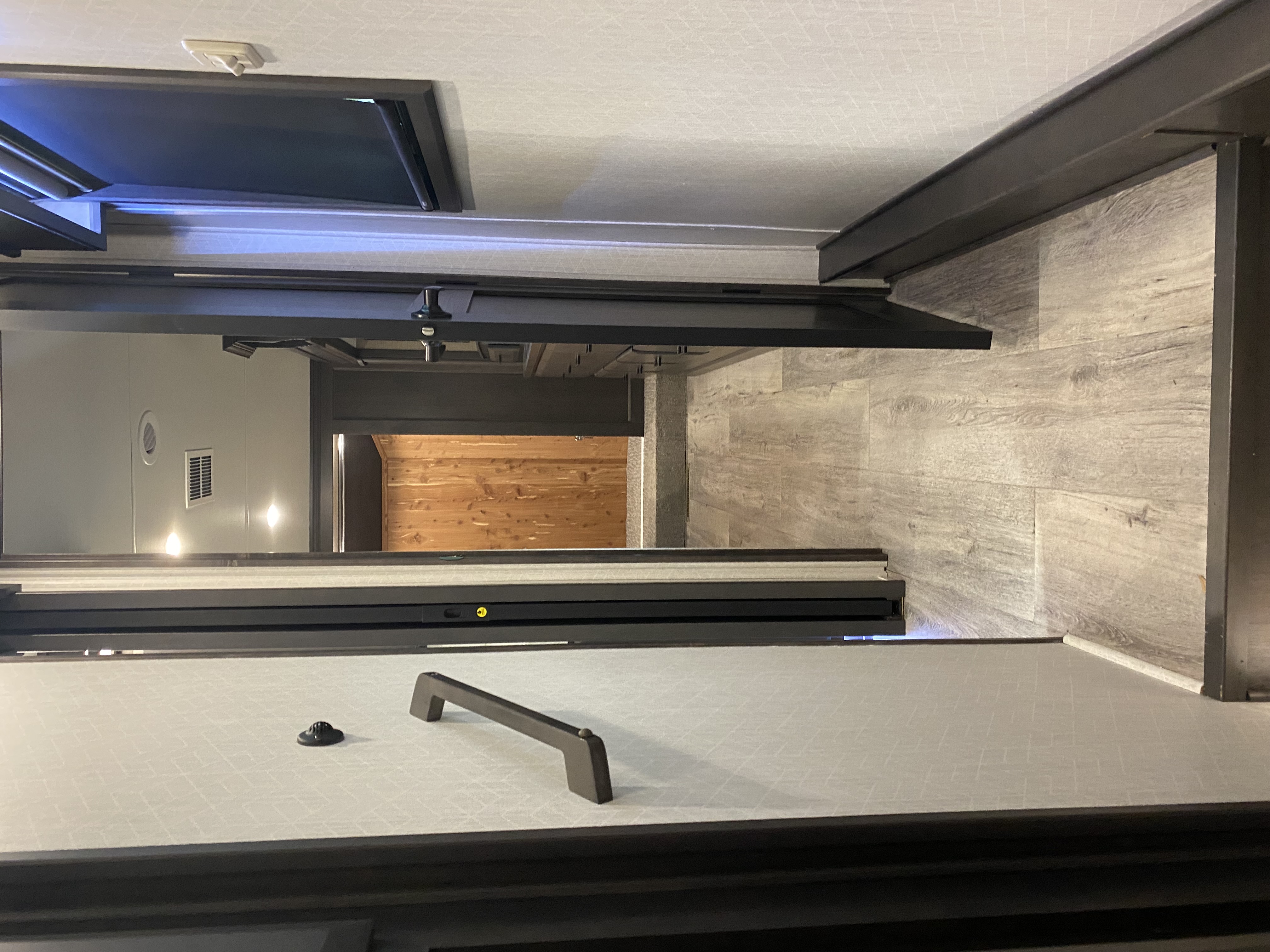 RV interior showing premium dark wood finishes and ambient lighting