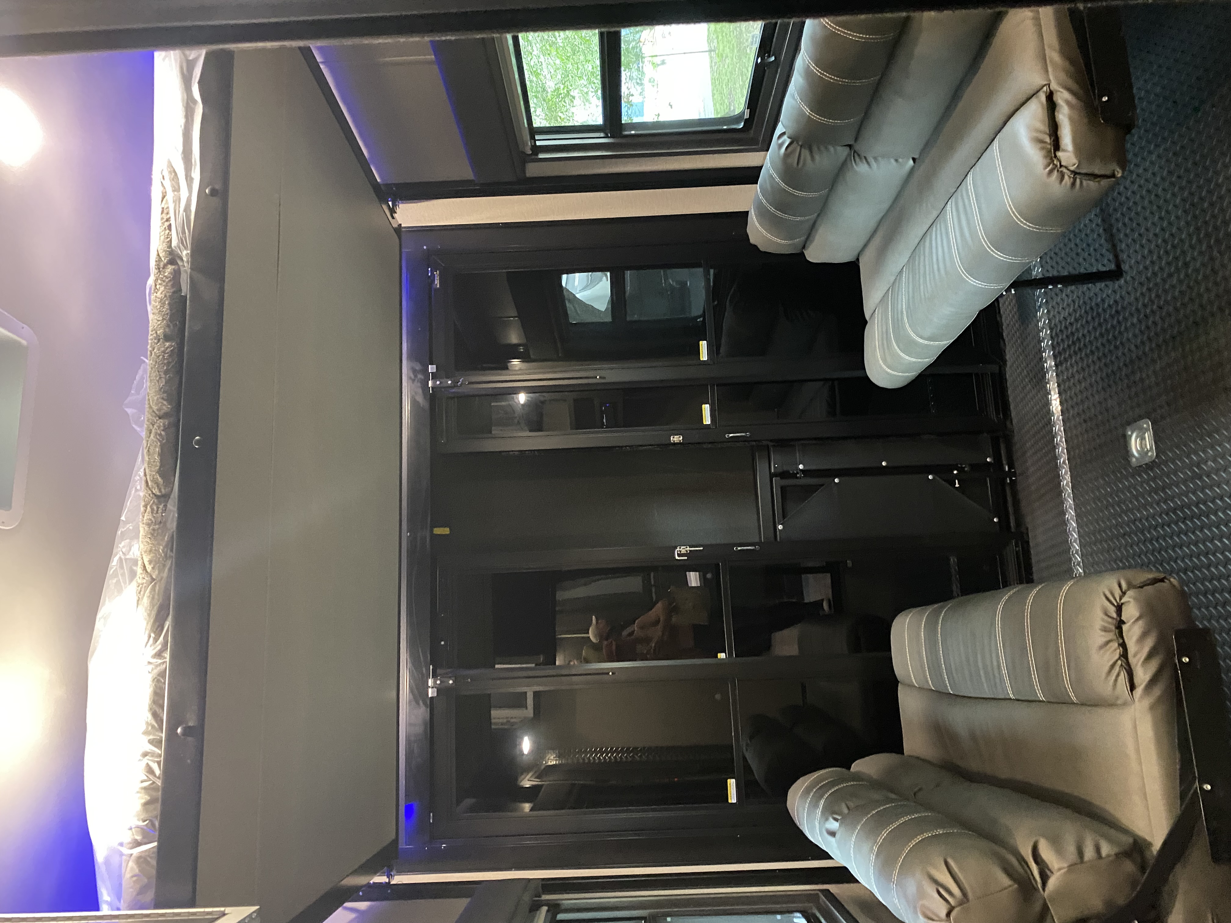 Spacious RV living area with modern decor and natural light