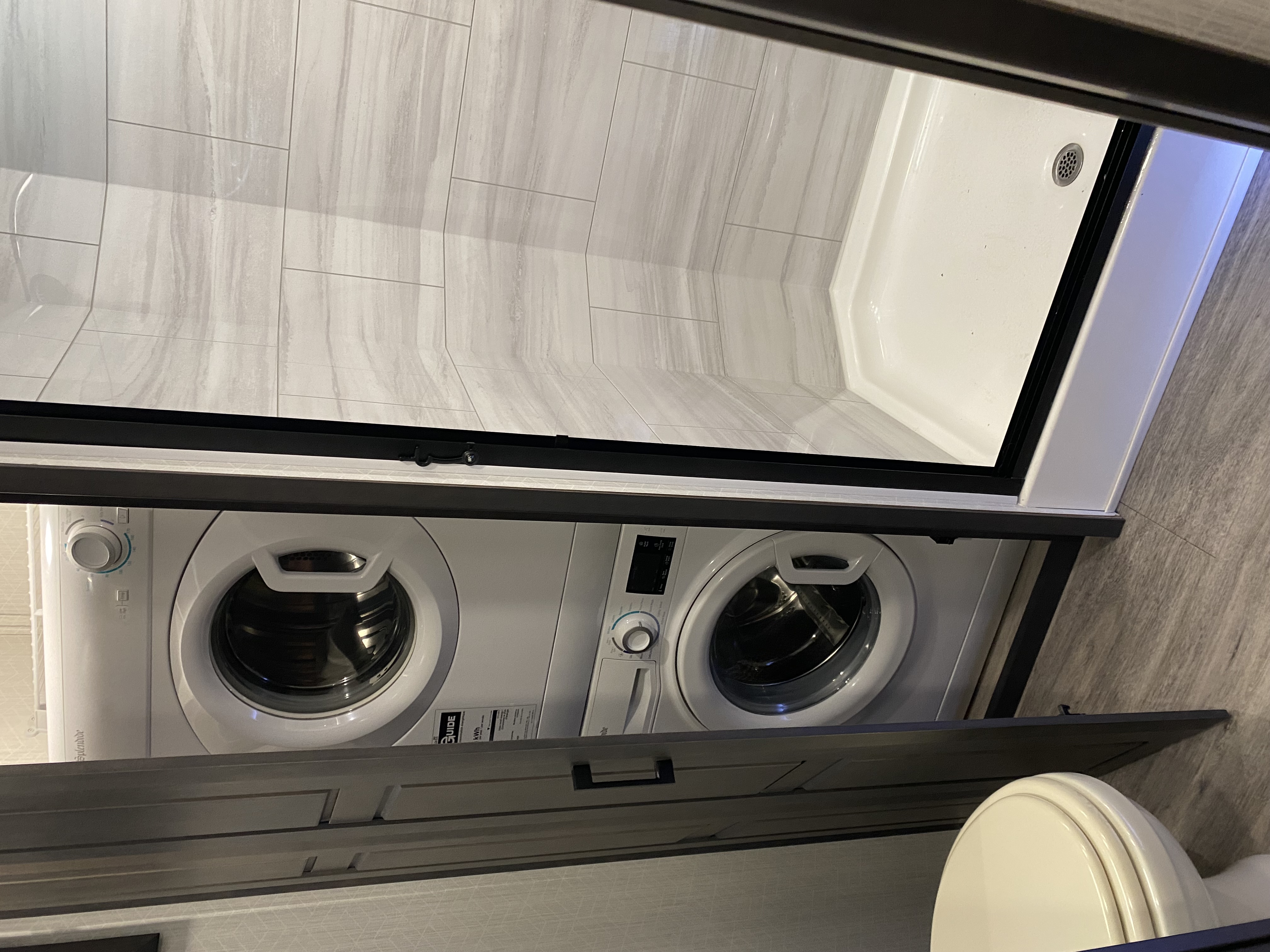 RV interior lounge seating area with dark cabinetry