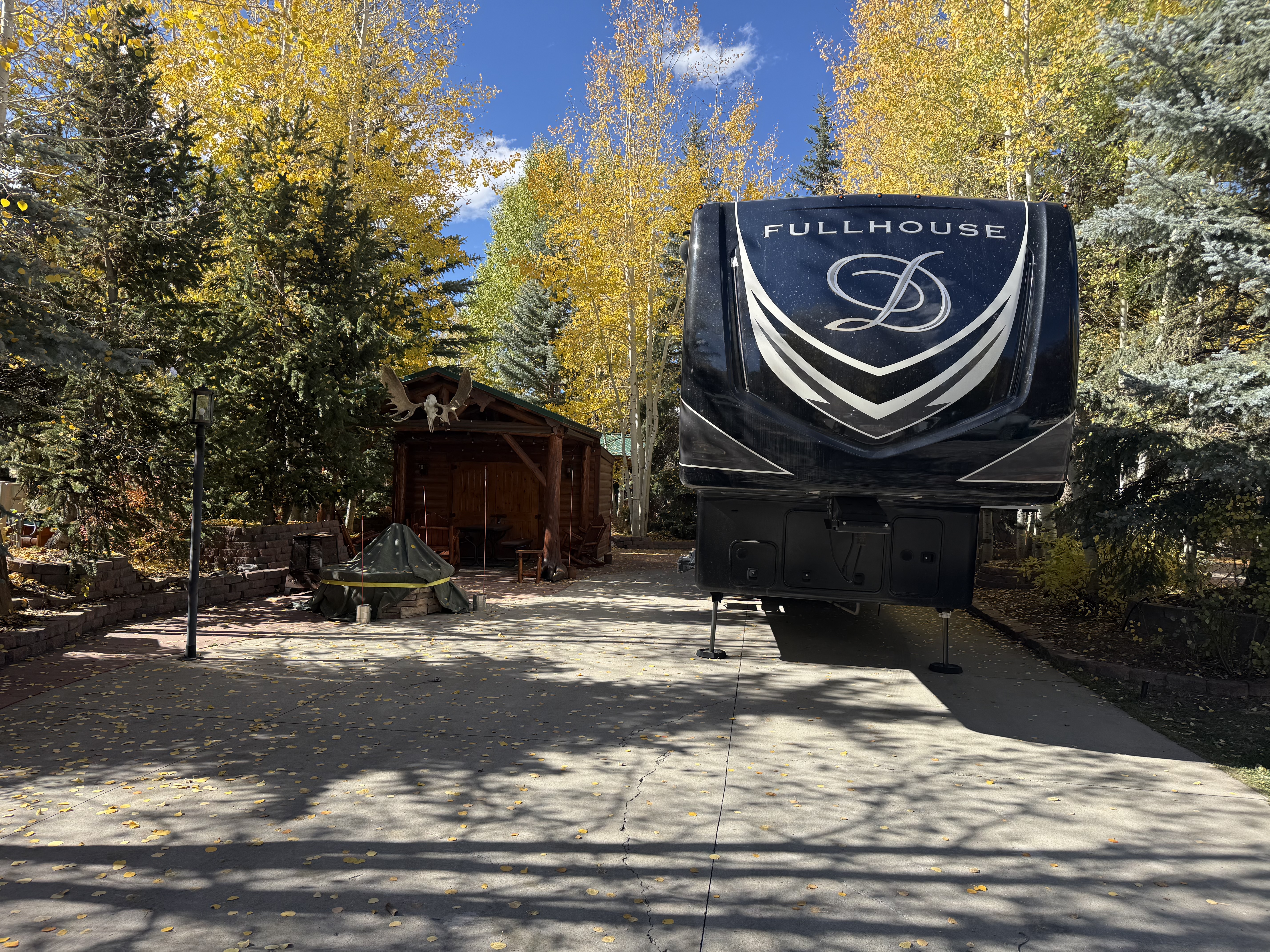 Luxury DRV FullHouse RV parked among golden aspens in Colorado mountains